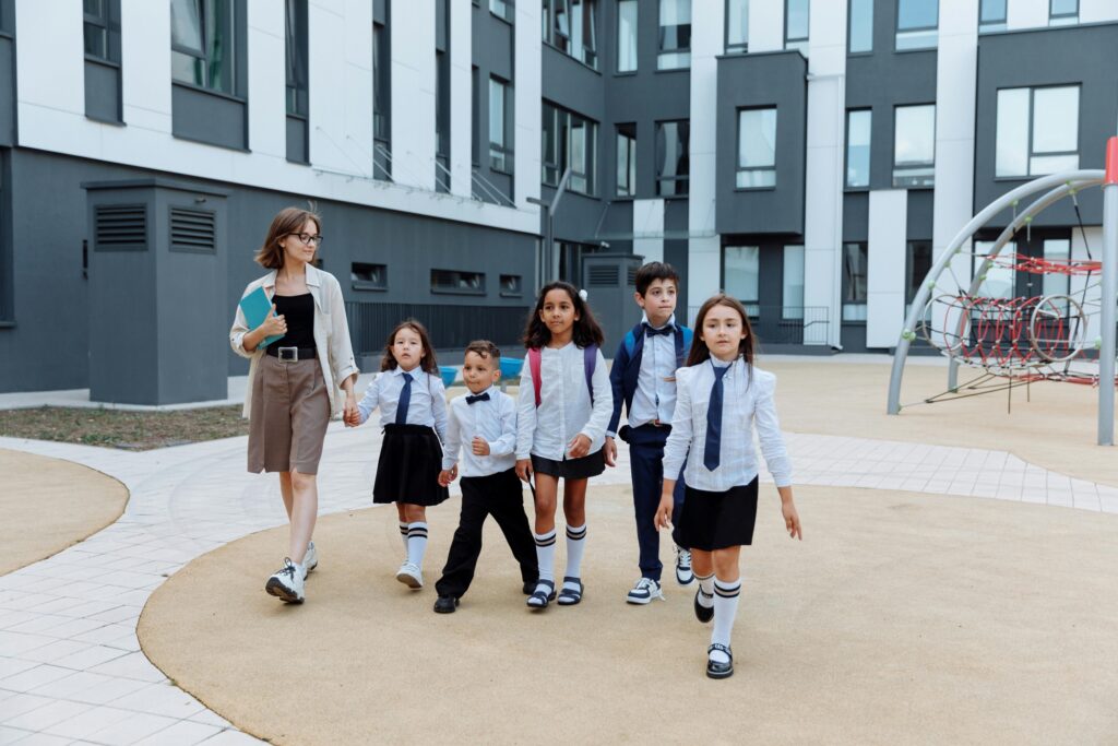 A teacher with her students walking around the school